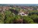 Aerial view of secluded estate, featuring a main house, outbuildings, and mature trees at 3214-3220 Tump Wilkins Rd, Stem, NC 27581