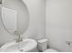 Clean bathroom with an oval mirror and pedestal sink at 332 Squirrel Oaks Ln, Garner, NC 27529