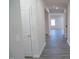 Bright hallway with light grey wood-look flooring at 332 Squirrel Oaks Ln, Garner, NC 27529