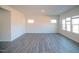 Bright living room with grey flooring and multiple windows at 332 Squirrel Oaks Ln, Garner, NC 27529