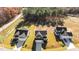 Aerial shot of three homes, displaying rooflines, driveways, and surrounding landscape at 41 Red River Dr, Selma, NC 27576