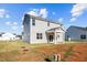 View of the home's back exterior, featuring a covered porch and gray siding at 41 Red River Dr, Selma, NC 27576