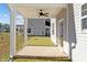 Covered back porch with ceiling fan overlooks the backyard at 41 Red River Dr, Selma, NC 27576