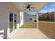 Covered back porch with ceiling fan overlooks the backyard at 41 Red River Dr, Selma, NC 27576
