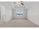 Bedroom with tray ceiling, ceiling fan, neutral walls and carpet, and a window at 41 Red River Dr, Selma, NC 27576