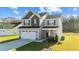 Two-story home featuring a gray facade, two-car garage, and well-maintained lawn, showcasing curb appeal at 41 Red River Dr, Selma, NC 27576