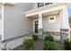 Inviting front porch featuring stone accents, stylish pillars and beautiful landscaping at 41 Red River Dr, Selma, NC 27576