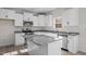 Updated kitchen features white cabinets, granite countertops, and stainless steel appliances at 41 Red River Dr, Selma, NC 27576
