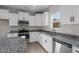 Updated kitchen features white cabinetry, granite countertops, and stainless steel appliances at 41 Red River Dr, Selma, NC 27576
