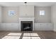 Cozy living room featuring a fireplace with built-in cabinets and wood-look flooring at 41 Red River Dr, Selma, NC 27576