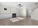 Open living room with fireplace, ceiling fan, and hardwood-style floors at 41 Red River Dr, Selma, NC 27576