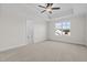 Serene main bedroom featuring plush carpet, tray ceiling, ceiling fan, and an ensuite bathroom entrance at 41 Red River Dr, Selma, NC 27576