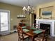 Dining room with hardwood floors, chandelier, and access to patio at 412 Airedale Trl, Garner, NC 27529