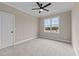 Well-lit bedroom with carpet, window, and ceiling fan at 55 Basil Ct, Franklinton, NC 27525