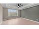 Bright bedroom with wood floors, large window, and accent wall at 55 Basil Ct, Franklinton, NC 27525