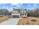 Two-story house with neutral siding, brown garage door, and landscaping at 55 Basil Ct, Franklinton, NC 27525