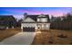 Two-story house with neutral siding, brown garage door, and landscaping at 55 Basil Ct, Franklinton, NC 27525