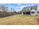 Two-story house back view, featuring a large backyard and screened porch at 55 Basil Ct, Franklinton, NC 27525