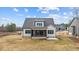 Back exterior view of two-story home with screened porch and yard at 55 Basil Ct, Franklinton, NC 27525