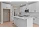 Modern kitchen with white cabinets, quartz countertops, and island at 55 Basil Ct, Franklinton, NC 27525