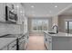 Modern kitchen with white cabinets, quartz countertops, and island at 55 Basil Ct, Franklinton, NC 27525