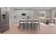 Modern kitchen with stainless steel appliances, island with barstool seating, and a view of the backyard at 55 Basil Ct, Franklinton, NC 27525