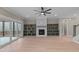 Living room with hardwood floors, fireplace, built-in shelves, and access to patio at 55 Basil Ct, Franklinton, NC 27525