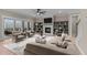 Inviting living room with a fireplace, built-in shelves, comfortable seating, and a large window with outdoor view at 55 Basil Ct, Franklinton, NC 27525