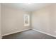 Simple bedroom with grey carpet and a window at 927 Micro W Rd, Selma, NC 27576