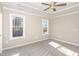 Bright bedroom with neutral walls, carpet, and two windows at 927 Micro W Rd, Selma, NC 27576