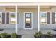 The front entrance features a glass door and gray siding at 927 Micro W Rd, Selma, NC 27576