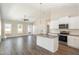 Modern kitchen with white cabinets, granite island, and stainless steel appliances at 927 Micro W Rd, Selma, NC 27576