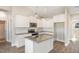 Modern kitchen with white cabinets, granite island, and stainless steel appliances at 927 Micro W Rd, Selma, NC 27576