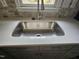 A stainless steel sink is under a window and set in a quartz countertop at 108 N Woodshed Ct, Cary, NC 27513