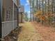 Home's backyard with screened porch and wooded area at 184 Dereham Ln, Garner, NC 27529