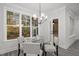 Breakfast nook with a glass table and chairs, offering a view of the backyard through large windows at 184 Dereham Ln, Garner, NC 27529