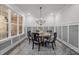 Elegant dining room featuring a round table, stylish chandelier, and a large window at 184 Dereham Ln, Garner, NC 27529