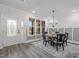 Elegant dining room featuring a round table, stylish chandelier, and lots of natural light at 184 Dereham Ln, Garner, NC 27529