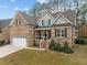 Charming brick two-story home with a well-manicured lawn and attached two car garage at 184 Dereham Ln, Garner, NC 27529