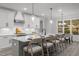 Gourmet kitchen with a spacious island, stainless steel appliances, and an adjacent dining area at 184 Dereham Ln, Garner, NC 27529