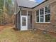 Screened porch with brick exterior and grassy yard at 184 Dereham Ln, Garner, NC 27529