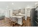 Well-lit kitchen featuring stainless steel appliances, center island with seating, and gray cabinetry at 2432 Pikes Peak Dr, Raleigh, NC 27616