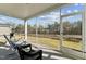 Relaxing screened-in porch with seating and outdoor views of the backyard and trees at 2432 Pikes Peak Dr, Raleigh, NC 27616