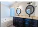 Main bathroom with double vanity, granite countertops, and a soaking tub at 360 Sandy Ridge Rd, Dunn, NC 28334