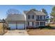 Two-story house with a two-car garage and landscaped yard at 360 Sandy Ridge Rd, Dunn, NC 28334