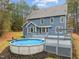 Exterior shot of large home, deck, covered pool, and spacious backyard at 5600 Thornburg Dr, Wake Forest, NC 27587