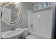Bathroom with white vanity, decorative mirror, and tiled shower/tub at 5600 Thornburg Dr, Wake Forest, NC 27587