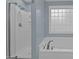 Bathroom featuring a large tub with chrome fixtures and a stand-up shower at 5600 Thornburg Dr, Wake Forest, NC 27587