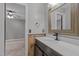Bathroom features a wooden vanity with white countertop, complemented by a rustic-framed mirror and views to the bedroom at 5600 Thornburg Dr, Wake Forest, NC 27587