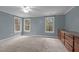 Spacious bedroom boasts carpeting, ample natural light from large windows, and a built-in dresser for storage at 5600 Thornburg Dr, Wake Forest, NC 27587